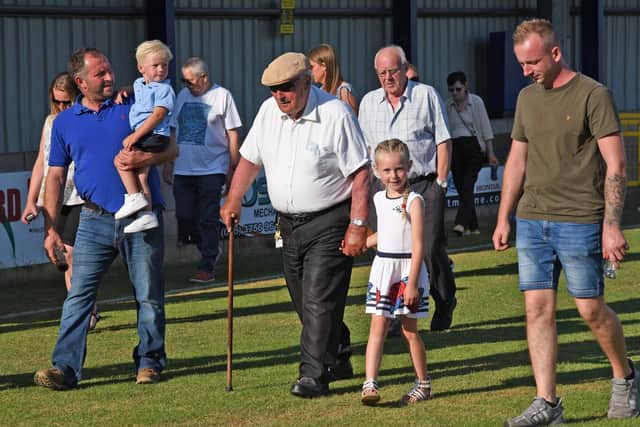 Hilbert Willis completing his 100-lap walk at Lakeview Park along with grandsons David and Adam and great-grandchildren Ollie and Amelia Lily. Pic courtesy of Loughgall FC