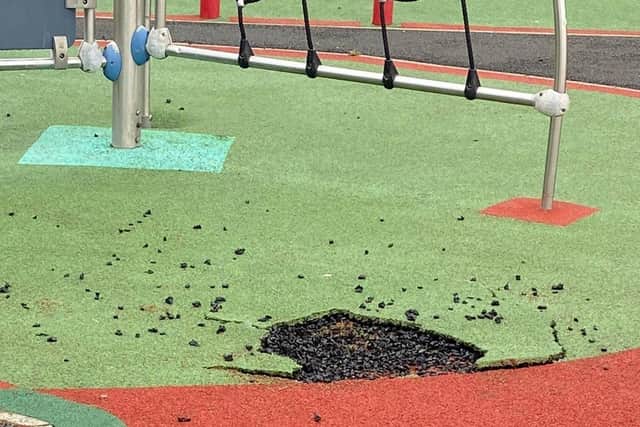Part of the soft play surface at Millburn Play Park in Coleraine has been ripped away, exposing the rough hard surface below and creating dangerous trip hazards