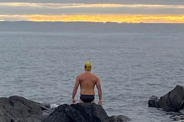 Portadown man Jordan Leckey standing at the rocks at Donaghadee looking at Scotland in the far distance as he embarks on his North Channel swim. He smashed the Guinness World Record, swimming it in nine hours, five minutes and 30 seconds.