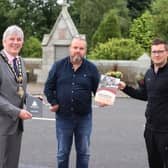The Mayor of Causeway Coast and Glens Borough Council Councillor Richard Holmes pictured during his recent visit to Dervock with Frankie Cunningham, Chair of Dervock & District Community Association and Matthew Hagan, chef/proprietor of The Pepper Mill café and Chairperson of Dervock Young Defenders Flute Band