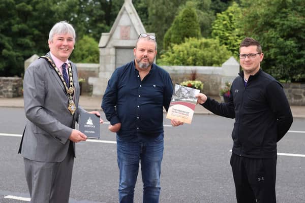 The Mayor of Causeway Coast and Glens Borough Council Councillor Richard Holmes pictured during his recent visit to Dervock with Frankie Cunningham, Chair of Dervock & District Community Association and Matthew Hagan, chef/proprietor of The Pepper Mill café and Chairperson of Dervock Young Defenders Flute Band