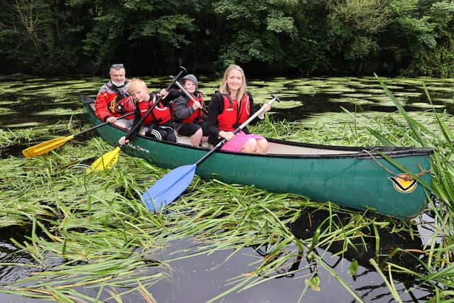 Chair of the Leisure & Community Development Committee, Councillor Sharon Skillen enjoys a paddle in a kayak along the Lagan Towpath with Graeme Larmour, Lisburn City Paddlers, Thomas McCutcheon and Jack Davidson, who attended Glenmore Activity Centre Summer Scheme
