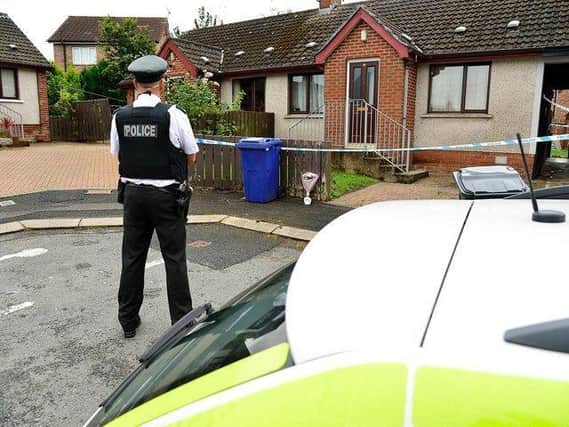 Police officer outside the house where the child suffered her injuries in Park Avenue, Dungannon.