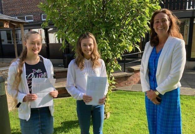 Lydia Weatherup 5 A star and 4 A grades with Joanna Nesbitt 7 A star and 3 A grades are congratulated by Dr Rainey Principal Ballyclare High School.