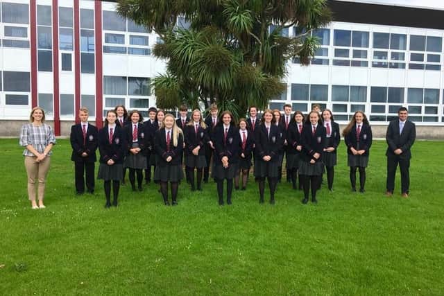 Carrickfergus Grammar School GCSE pupils with  nine or more A star and A grades, included are principal James Maxwell and head of year Mrs Best