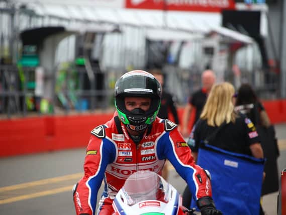 Honda Racing's Glenn Irwin crashed out of Sunday's opening British Superbike race at Donington Park after he was tagged from behind.