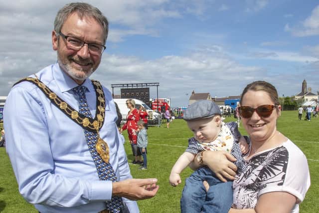 This young visitor to the Centenary Garden Party says 'hello' to the Mayor, Councillor William McCaughey.