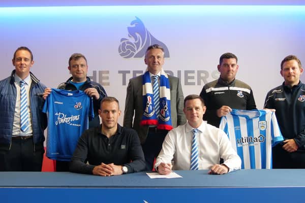 Pictured at the signing of the agreement seated (left to right): Emyr Humphries (Academy Manager Huddersfield Town FC) and David Johnstone (Loughgall FC - Youth Development Manager).
Standing (left to right): James Johnston (LFC Vice Chairman and LFC Youth Chairman), Ernie Smyth (LFC Youth Vice Chairman), Sam Nicholson (LFC Chairman), Dean Smith (LFC 1st Team Manager) and Denver Calvin (LFC Youth Committee Member)