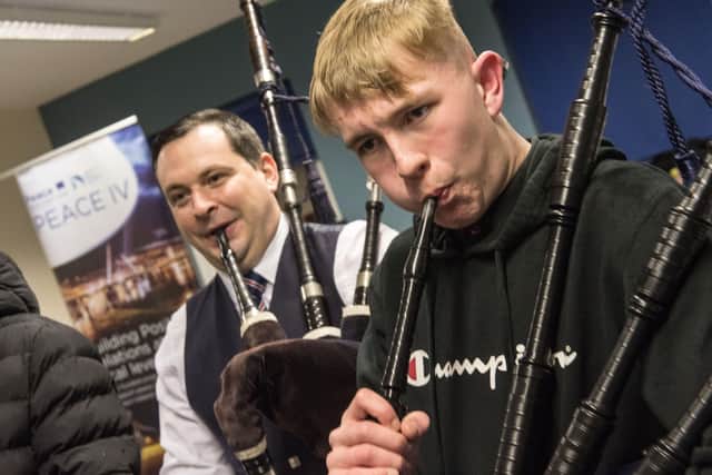 Piping tutor Darren Milligan with  Ben Hughes-Hynds who is taking part in a tin whistle and piping workshop in Newbuildings Youth and Community Centre organised by the NW Cultural Partnership and funded by PEACE IV with Andrew Lynch, tutor. Picture Martin McKeown.