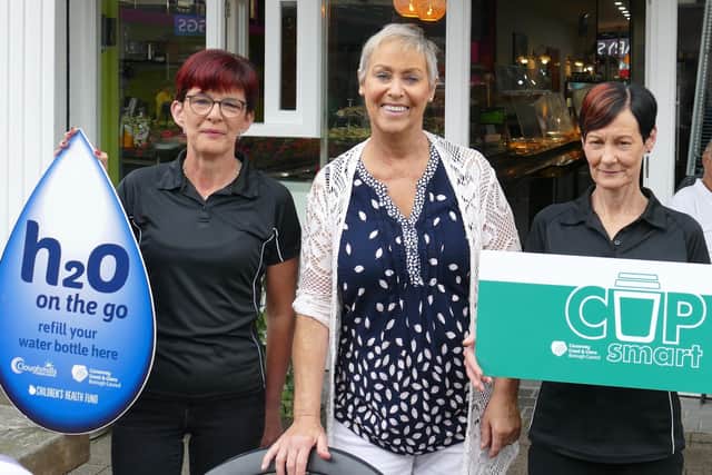 Paula O'Kane, owner of Herald's at 22 in Coleraine marks her participation in Causeway Coast and Glens Borough Council’s CupSmart and H20 On The Go schemes with staff members Theresa and Louise