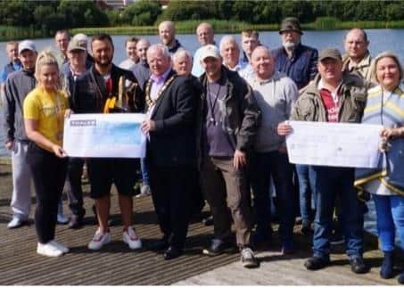 Anglers pictured at the dam in 2019 with then Mayor, Ald John Smyth.