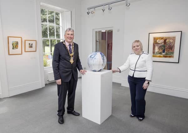 Mayor of Causeway Coast and Glens Borough Council, Councillor Richard Holmes, and Chairperson of Council’s NI 100 Working Group, Councillor Michelle Knight-McQuillan view the Causeway Collection 100 exhibitio opened to the public as part of Council's NI 100 programme