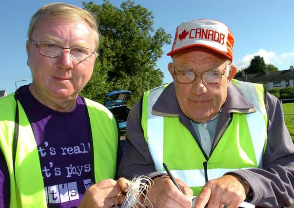 Dennis Bell and Sam Stockman complete the final forms prior to the start of the Mid-Ulster Vintage Vehicle Club’s sponsored two day tractor and car trek from Moneymore to Castlerock and return in aid of ME Research in August 2010. Picture: Simon Robinson/Mid Ulster Mail archives