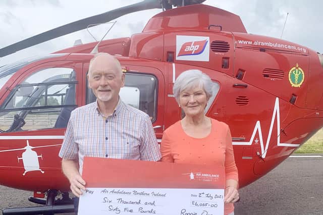 Ronnie and wife Sylvia Orr presenting cheque to Air Ambulance NI