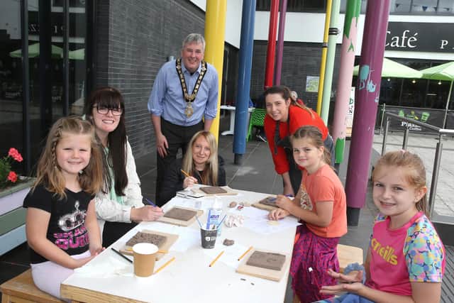 Artist Fiona Shannon and the Mayor of Causeway Coast and Glens Borough Council, Councillor Richard Holmes, pictured with  some of the young participants at the ceramic tile workshop for the ‘Our Story in the Making’ art piece