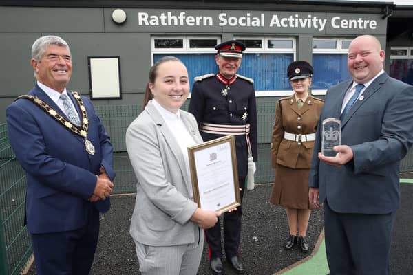 Megan Beattie and George Hill accepting the Queen's Award for Voluntary Service on behalf Rathfern Community Regeneration Group. They are joined by the Lord Lieutenant of County Antrim, Mr David McCorkell, Mayor of Antrim and Newtownabbey, Councillor Billy Webb and Cadet Ciara McKay.