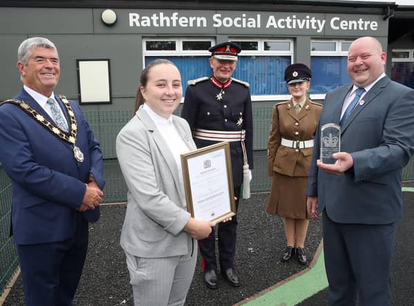 Megan Beattie and George Hill accepting the Queen's Award for Voluntary Service on behalf Rathfern Community Regeneration Group. They are joined by the Lord Lieutenant of County Antrim, Mr David McCorkell, Mayor of Antrim and Newtownabbey, Councillor Billy Webb and Cadet Ciara McKay.
