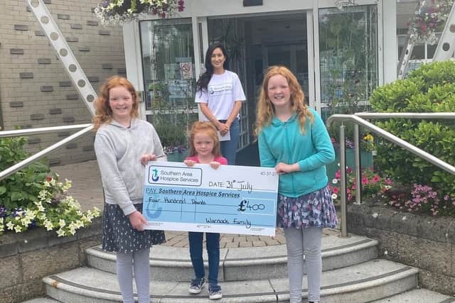 Pictured is Bernie Byrne, Southern Area Hospice Fundraising Officer, accepting the cheque for £400 from Abigail, Joy and Lydia Warnock.