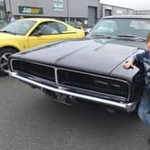 Archie Barr admiring a Dodge Charger.