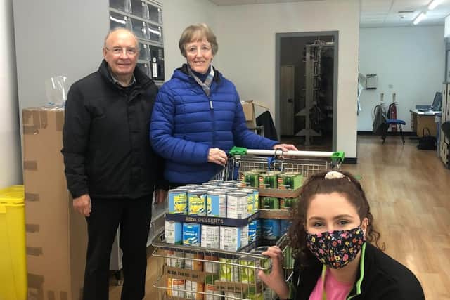 Asda Ballyclare customers donated 2,584 meals to the Newtownabbey Foodbank in a recent food drive. The store's Community Champion Emma Cross is pictured with Foodbank volunteers Dorothy and Ewan McCullough.