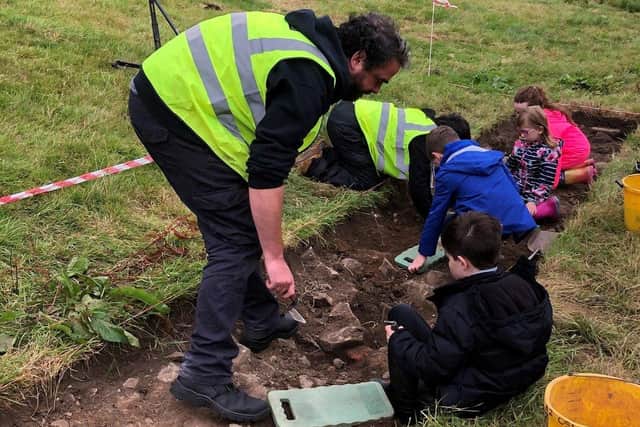 Pupils from the Archaeology Summer Scheme at Newmills Primary School take part in the excavation organised by Lough Neagh Partnership in the village