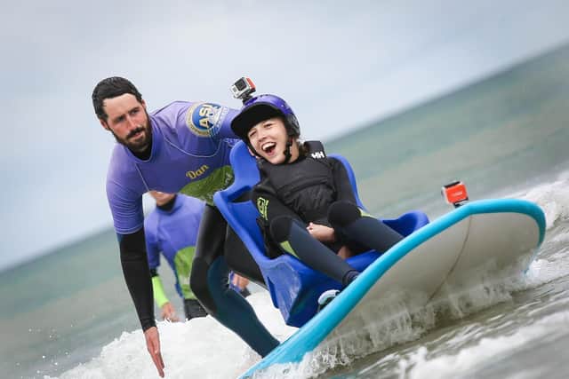 Talia and instructor Dan taking to the waves with the Mae Murray Foundation.