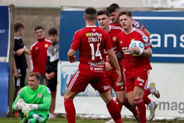 Ruairi Croskery running back with the ball to restart Saturday’s play after cutting the gap to 2-1 for Portadown in defeat to Larne. Pic by Pacemaker.