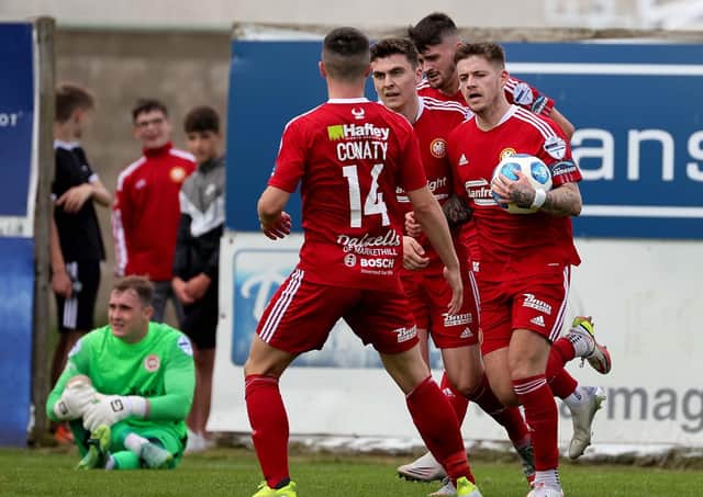 Ruairi Croskery running back with the ball to restart Saturday’s play after cutting the gap to 2-1 for Portadown in defeat to Larne. Pic by Pacemaker.