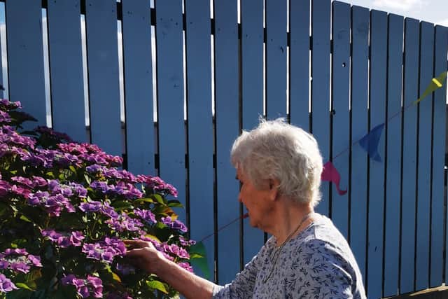 Margaret Brown admires the plants.