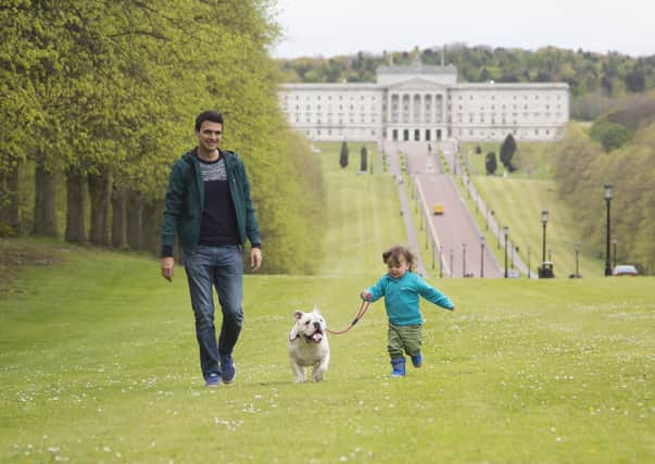 Ollie and son, Jude, enjoying a dog walk at Stormont Estate (Picture: Cancer Focus NI)