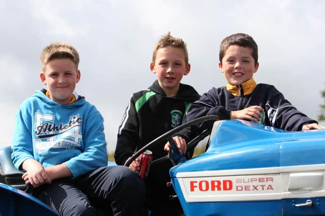 Mark Haughey, Michael McDonnell and Ryan Forde sit on a Ford Dexta tractor at the Country Fair at Glenravel Festival in August 2009. The tractor had special significance for the boys as it used to belong to their grandfather Arthur McDonnell. Picture: John McIlwaine/Ballymena Times/Farming Life archives