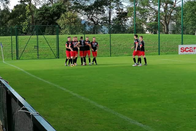 Ballyclare Comrades players congratulate Andy Mooney following his goal at The Dub.