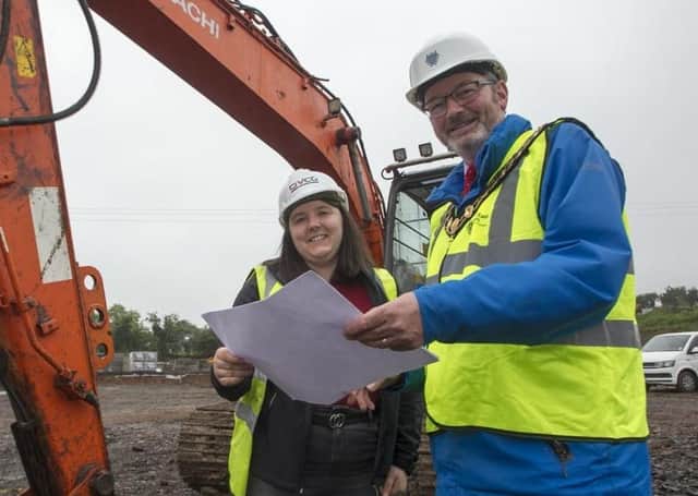 The Mayor of Mid and East Antrim, Cllr William McCaughey and Jessica Stronge, site manager, from CIVCO., look over the plans at Sullatober household recycling cente.