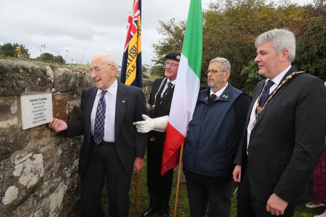Ernest Nardone looks at the memorial plaque erected in his father’s memory at Bonamargy Friary along with Leonard Quigg and James McCurdy from Ballycastle Royal British Legion and the Mayor of Causeway Coast and Glens Borough Council Councillor Richard Holmes