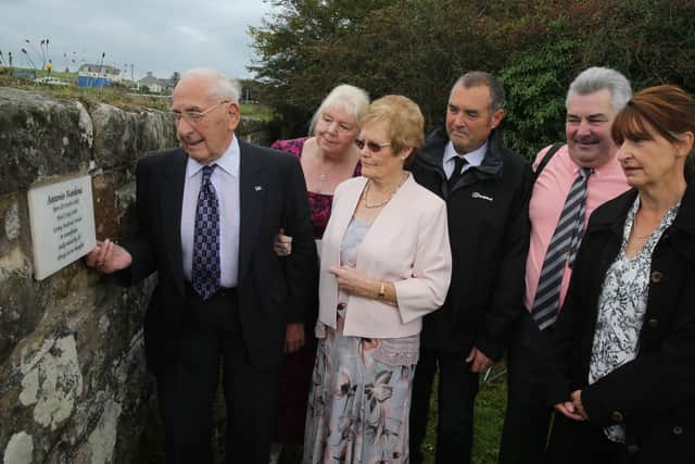 Antonio Nardone’s son Ernest, and members of the Nardone family, look at the memorial stone which is now in place at Bonamargy Friary
