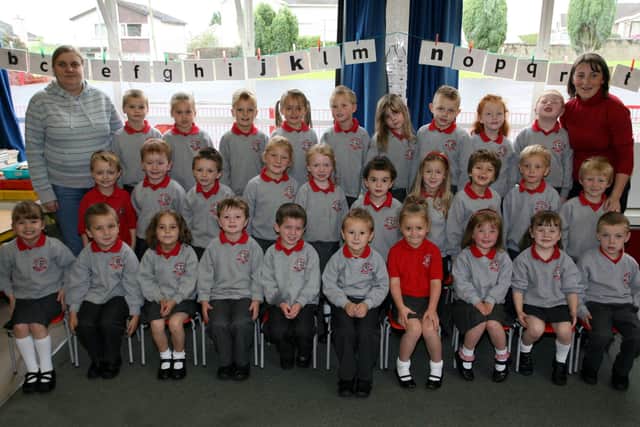 Miss K. McCartney and Mrs. C. McCavana pictured with Carniny Primary School's P-1 class. BT39-021JM.