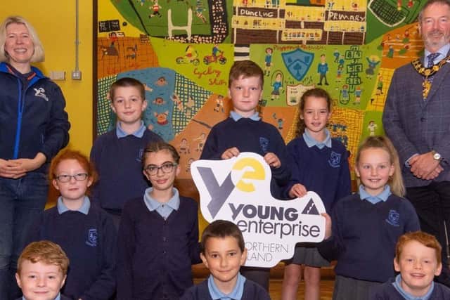 YENI's Emma Crawford and Mayor of MEABC Cllr William McCaughey with pupils from Dunclug PS