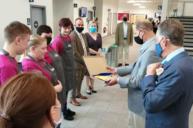 Prince Edward, Earl of Wessex  at the official opening of Armagh, Banbridge and Craigavon's South Lakes Leisure Centre. Here he is being presented with some lollipops by staff from Cafe Incredable.