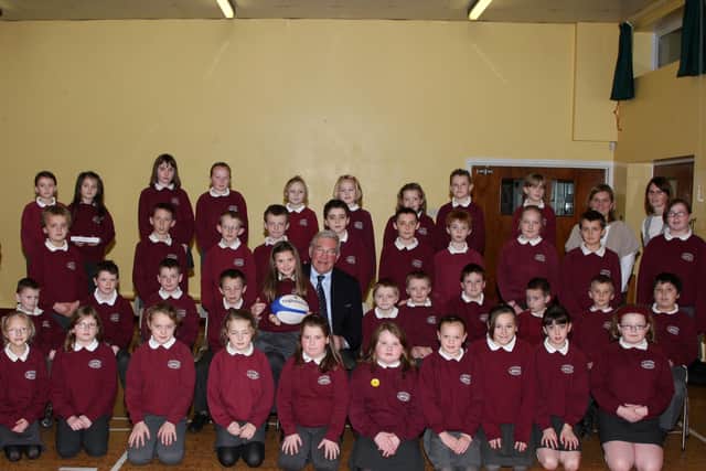 Chairman of the International Rugby Board and Chairman of Rugby World Cup Syd Millar, who gave a talk to pupils at the Diamond Primary School, Ahoghill. Included is Mr Millar’s granddaughter Hannah and the school’s sports Coaches Mrs Jayne Stewart and Mrs Karen Corry. BT50-111JC