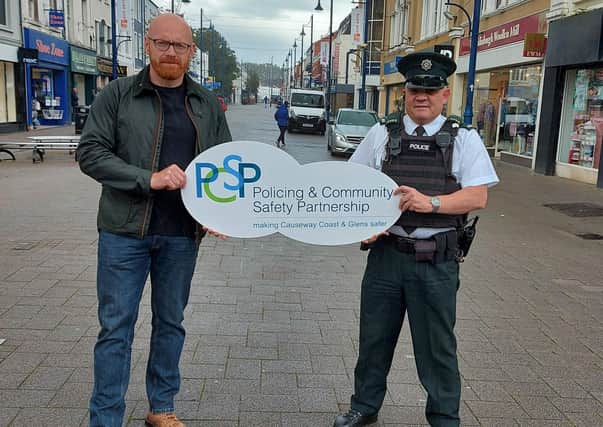 The Chairperson of Causeway Coast and Glens Policing and Community Safety Partnership Councillor Darryl Wilson pictured in Coleraine town centre with Constable Peter Olphert. The PSCP and PSNI are urging the public to be on their guard against High Street Voucher scammers