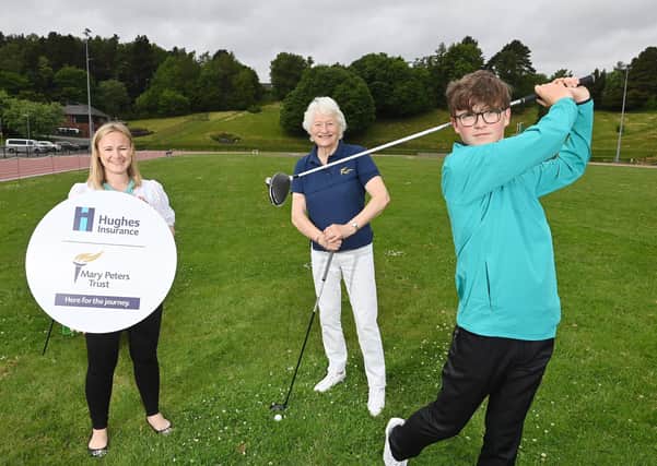Lisburn golfer Fionn Dobbin is pictured with Harriet McCandless, Senior Marketing Manager at Hughes Insurance and Lady Mary Peters