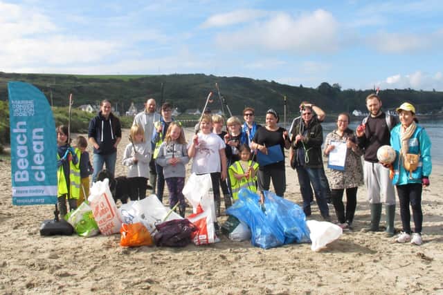 Elena Aceves-Cully (right), organiser of the beach clean-up, with volunteers at Islandmagee.