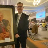 DUP leader Sir Jeffrey Donaldson poses with a painting of the party's founding leader Rev Ian Paisley, by Kenny McKendry, at a Belfast dinner to mark the 50th anniversary of the founding of the party.