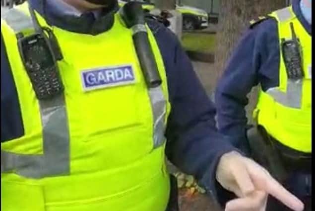 One of three Garda officers in the process of arresting three men from Northern Ireland while they were preaching using a public address system in Dundalk.