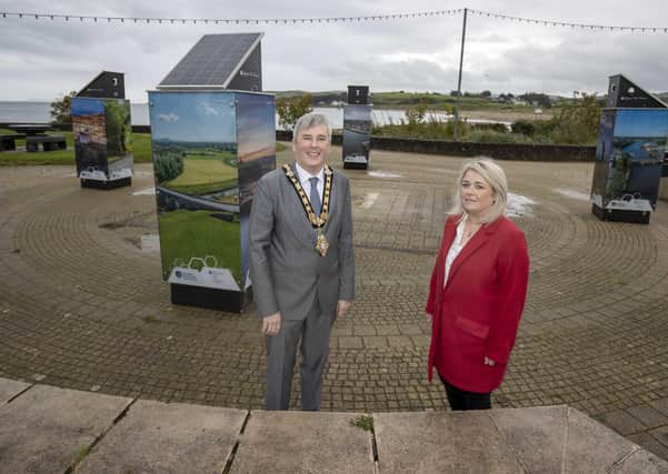 The Mayor of Causeway Coast and Glens Borough Council Councillor Richard Holmes pictured in Ballycastle where four new light boxes are on display featuring iconic imagery from around the Borough with Town & Village Project Officer Geraldine Wills
