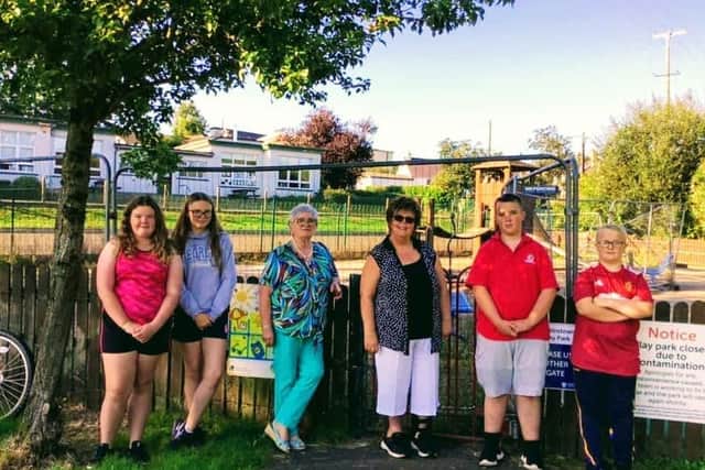 Cllr Adger at Martinstown Play area with local young people and Marian Maguire  (Glenravel  & District Community and Residents Association)