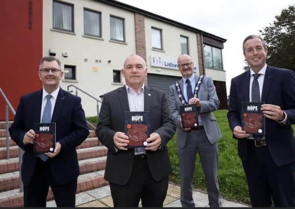 Sir Jeffrey Donaldson MP, Deputy Mayor Tim Mitchell, First Minister Paul Givan, Resurgam Trust Director Adrian Bird launch the second book produced by the Trust Stories of Hope.