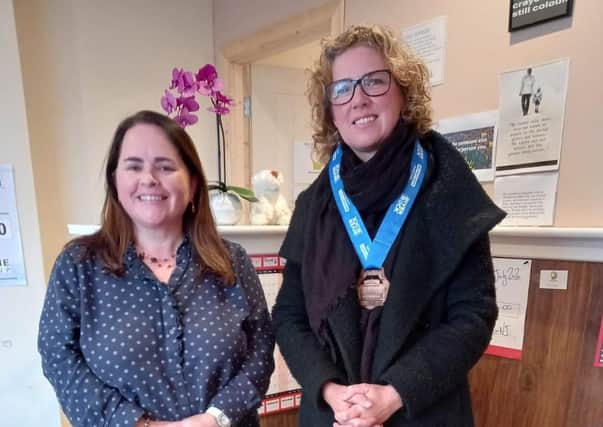 Gillian Kelly (right) who ran the Belfast Marathon in under four hours in aid of the Olive Branch mental health counselling service in Coleraine. Gillian, who raised £1,150 for the charity, is pictured with counsellor Deirdre Walford