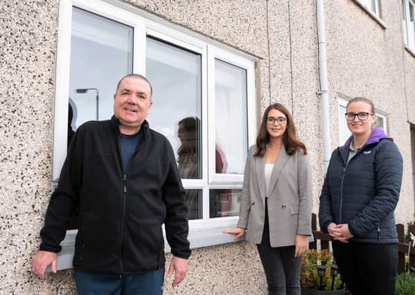 Pictured outside his home with his new windows is tenant Geoffrey Edgar along with Misha Kelly (Housing Executive patch manager) and Helen Doherty (CFM)