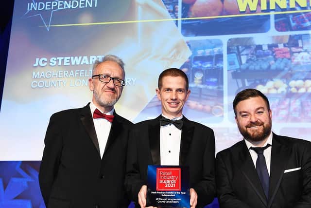David Shrimpton, Editor of Independent Retail News (left) is pictured with Gary McCulloch from JC Stewart in Magherafelt, who picked up the Fresh Produce Retailer of the Year award at the prestigious Retail Industry Awards in London. Also pictured is host of the awards ceremony, Alex Brooker.